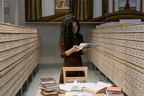Woman reading in an archive library