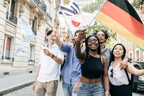 Student waving flags representative of countires