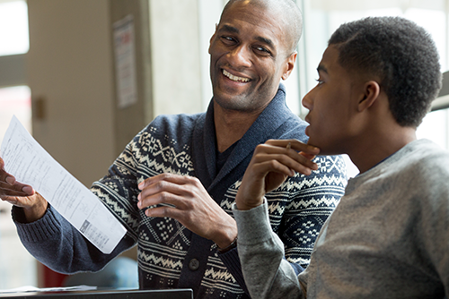 Teacher speaking with student
