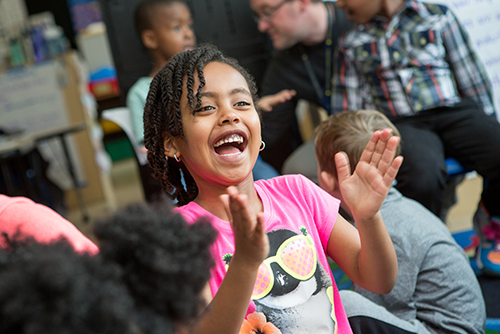 Student laughing and clapping