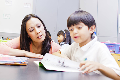 Teacher reading with student