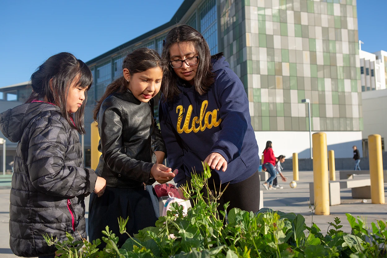 Students gardening with teacher at UCLA Community School