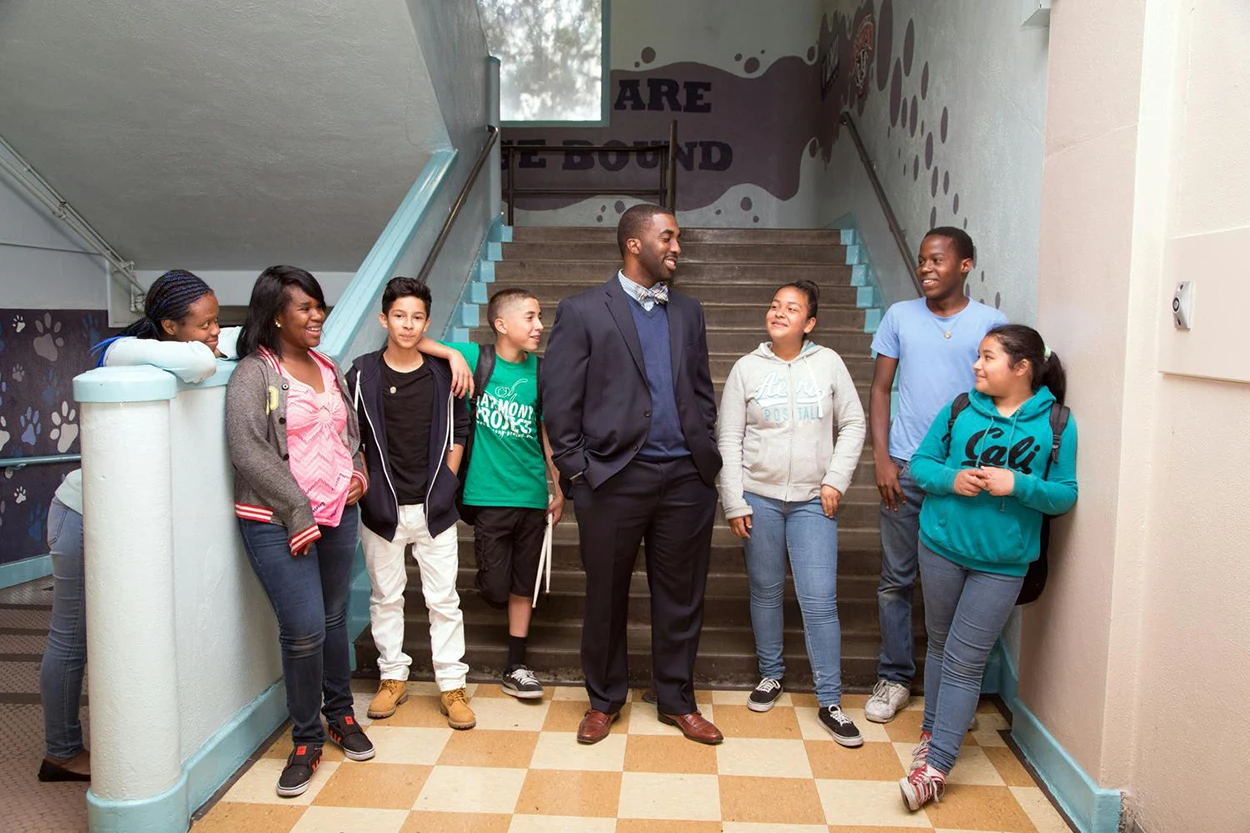 Orlando Johnson with students on school staircase