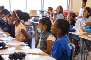 Students at desks with masks